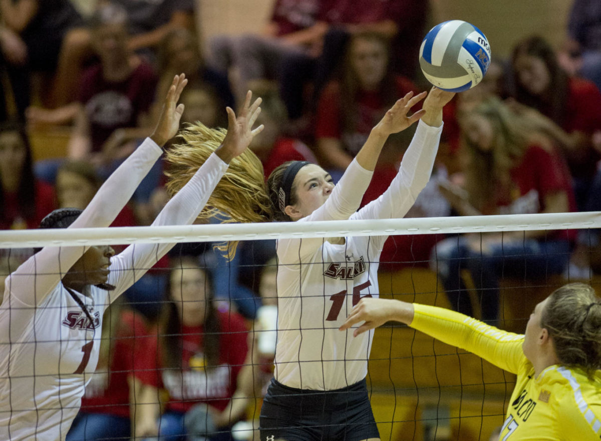 Senior middle hitter Kolby Meeks (left) and senior outside hitter Abby Barrow (right) block the ball Monday, Sept. 25, 2017, during the Salukis 2-1 win against Valparaiso University at Davies Gym. (Dylan Nelson | @Dylan_Nelson99)