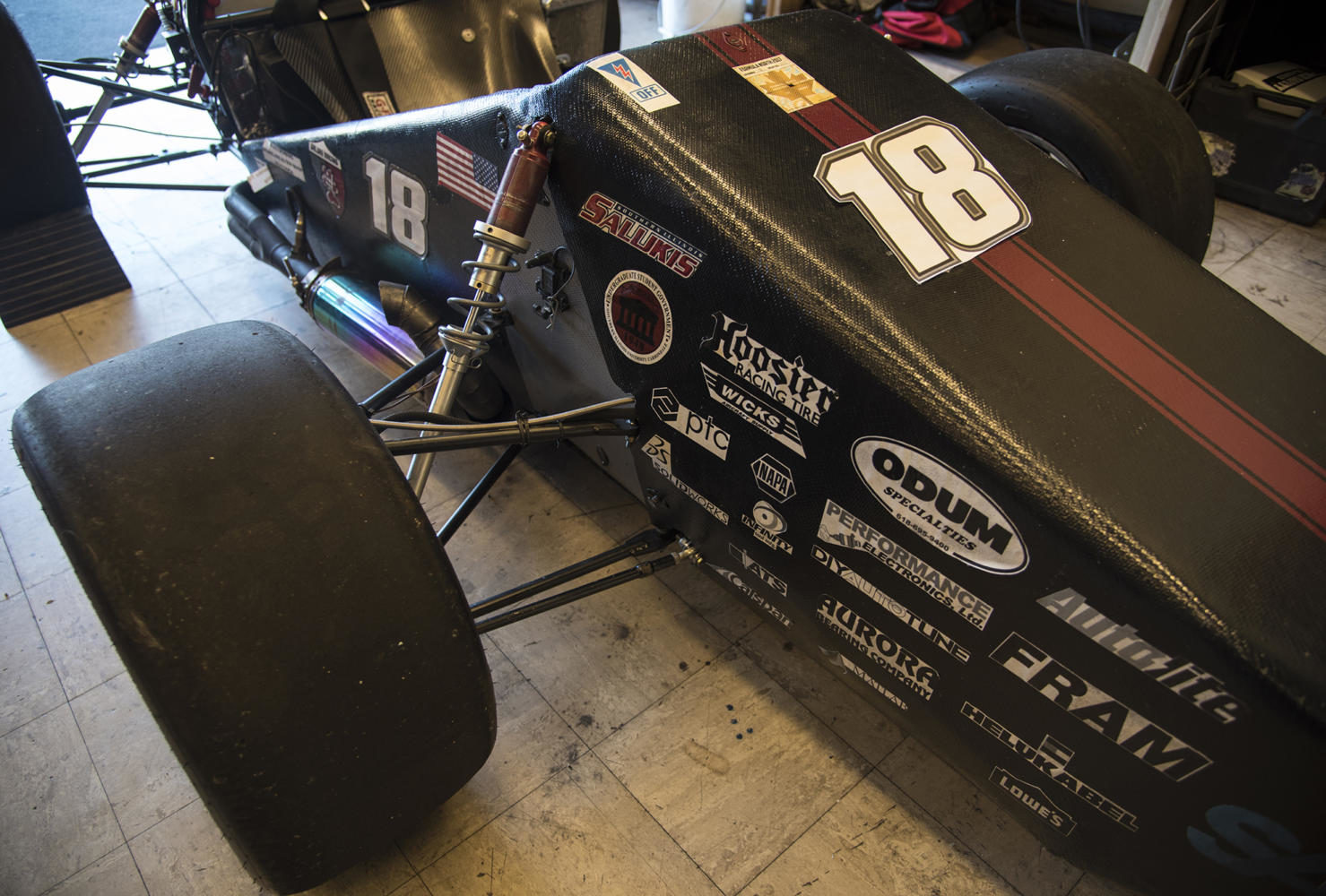 The hood of the race car Saluki KA displays sponsorship stickers in the shop Friday, Sept. 15, 2017, in the shop in the engineering building. (Athena Chrysanthou | @Chrysant1Athena)