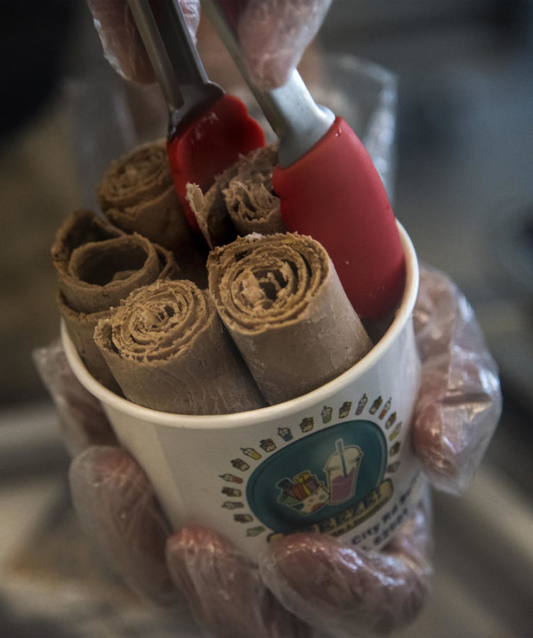 Thai ice cream rolls are placed into serving cup, Monday, Oct. 9, 2017, at Freeze in Carbondale. (Mary Newman | @MaryNewmanDE)