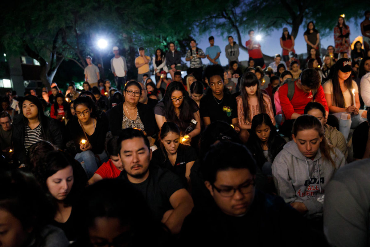 UNLV students hold a moment of silence for the victims of the mass shooting that killed 59 people and injured more than 525 on Oct. 2, 2017 in Las Vegas. (Marcus Yam/Los Angeles Times/TNS)