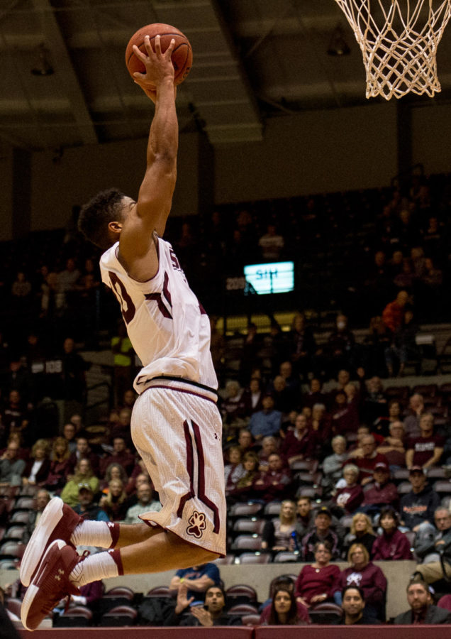 Sophomore guard Aaron Cook goes for a slam dunk Saturday, Nov. 18, 2017, during the Salukis' 69-64 win against the University of Illinois Springfield Prairie Stars at SIU Arena. (Brian Muñoz | @BrianMMunoz)