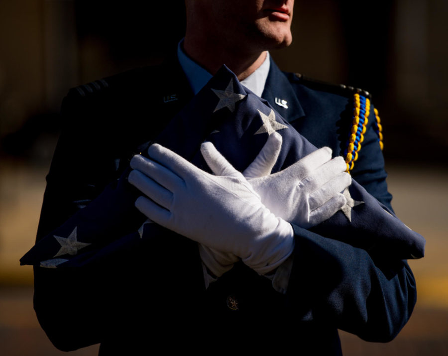 Air Force ROTC cadet Matthew Merdian, a senior aviation management, holds the American flag Friday, Nov. 10, 2017, during the annual Veterans Day ceremony at Veterans Memorial Plaza. (Brian Muñoz | @BrianMMunoz)