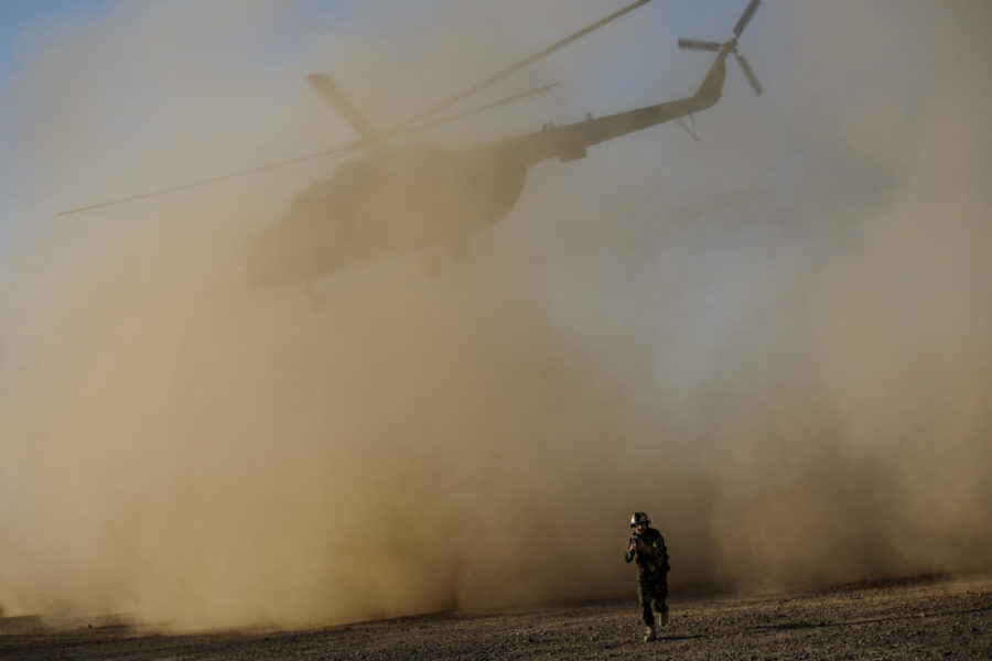 A soldier with the Afghan army leaves the landing site as an Afghan Mi-17 takes off during training near Camp Shorab, in Helmand Province. (Marcus Yam/Los Angeles Times/TNS)