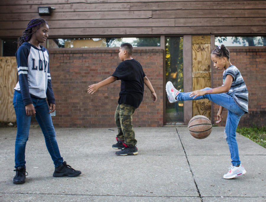 Nicyah Hastings-Atkins, 9, right, plays with a basketball as Malachi Suggs, 10, center practices his moves and ANiyah Black, 13, watches outside of the Eurma C. Hayes Center on Wednesday, Aug. 23, 2017, in Carbondale. We saw Malachi walking over there, Hastings-Steele said. Nicyah saw he had a basketball, so we asked if he wanted to play. The group had never met before this evening. (Ryan Michalesko | @photosbylesko)