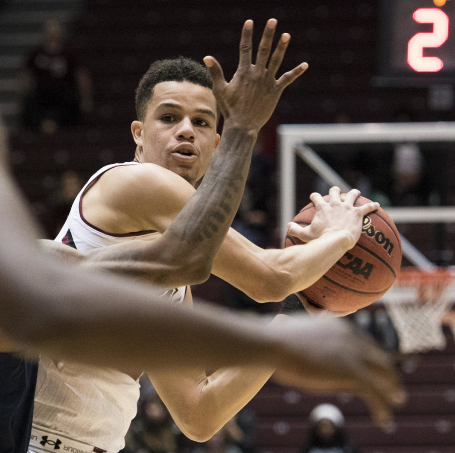 Senior forward Jonathan Wiley holds the ball under Tiger defense Wednesday, Dec. 13, 2017, during the Salukis 69-51 win against the Jackson State Tigers at SIU Arena. (Dylan Nelson | @Dylan_Nelson99)