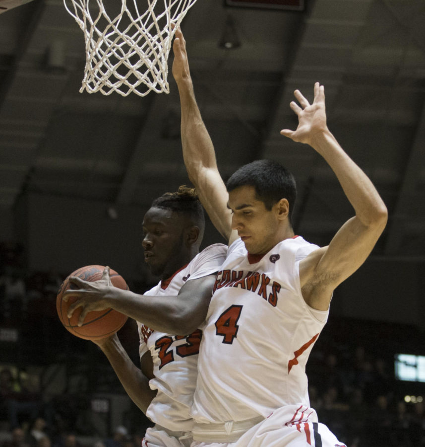 Redhawk senior guard Daniel Simmons (23) and senior guard Milos Vranes blocks the ball Saturday, Dec. 9, 2017, during the Salukis’ 75-69 loss against the Southeast Missouri Redhawks at SIU Arena. (Dylan Nelson | @Dylan_Nelson99)