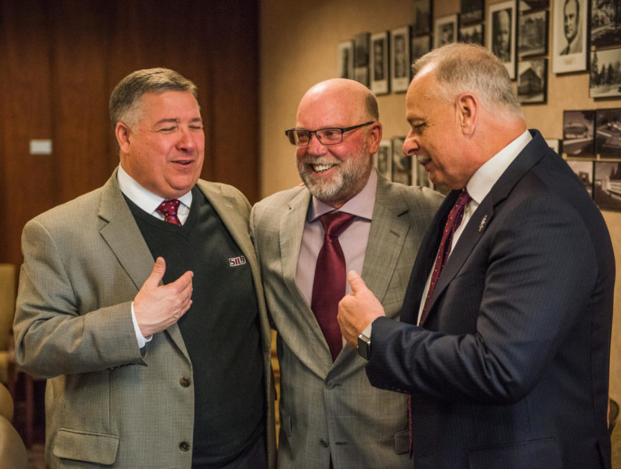 From left: Tommy Bell, SIU Director of Athletics, Jerry Kill, special assistant to the chancellor, and Carlo Montemagno, SIU Chancellor chat Tuesday, January. 30, 2018, after the public announcement of Kill's appointment to serve as an ambassador and fundraiser for the university in Anthony Hall. (Brian Munoz | @BrianMMunoz)