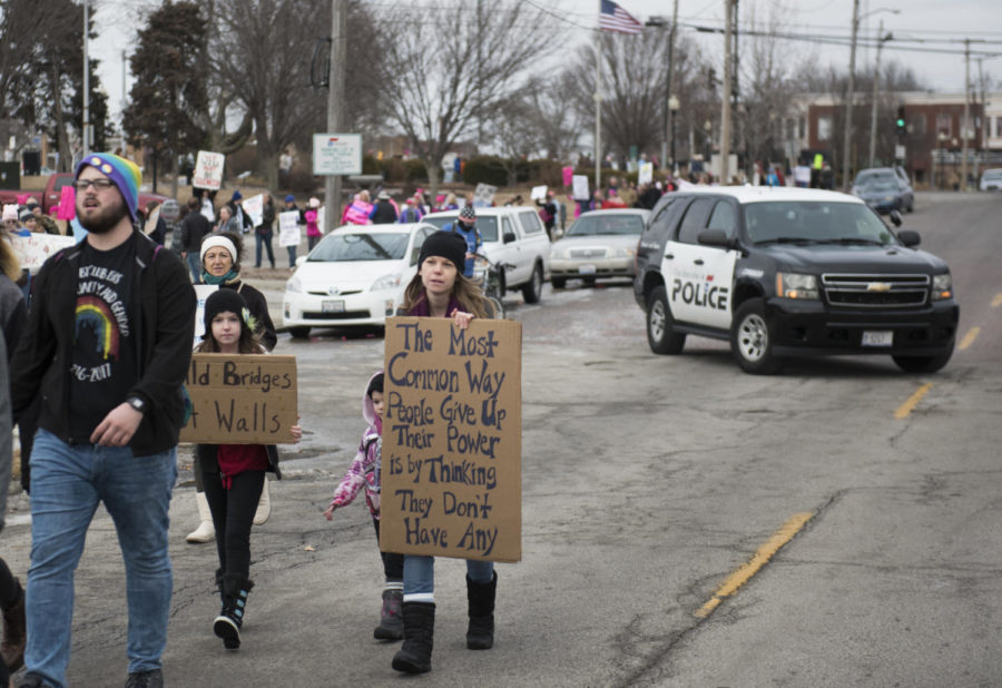 A mother and her daughter march along with many others while police block off traffic Saturday, Jan. 20, 2018 during the Southern Illinois March to the Polls in Carbondale. (Dylan Nelson | @Dylan_Nelson99)