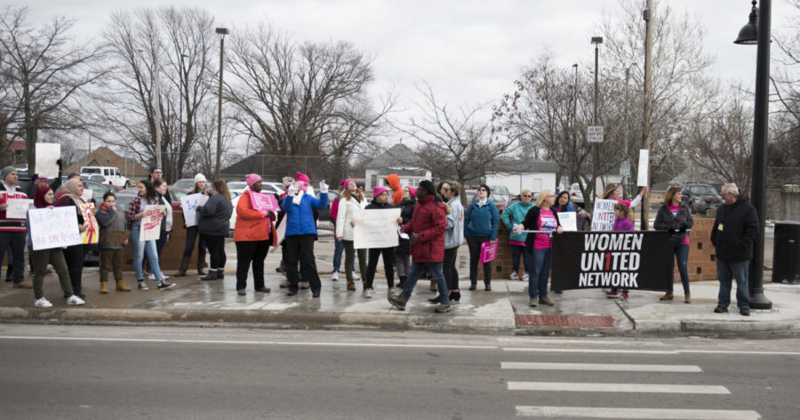 Protesters wait to cross a busy street Saturday, Jan. 20, 2018 during the Southern Illinois March to the Polls in Carbondale. (Dylan Nelson | @Dylan_Nelson99)