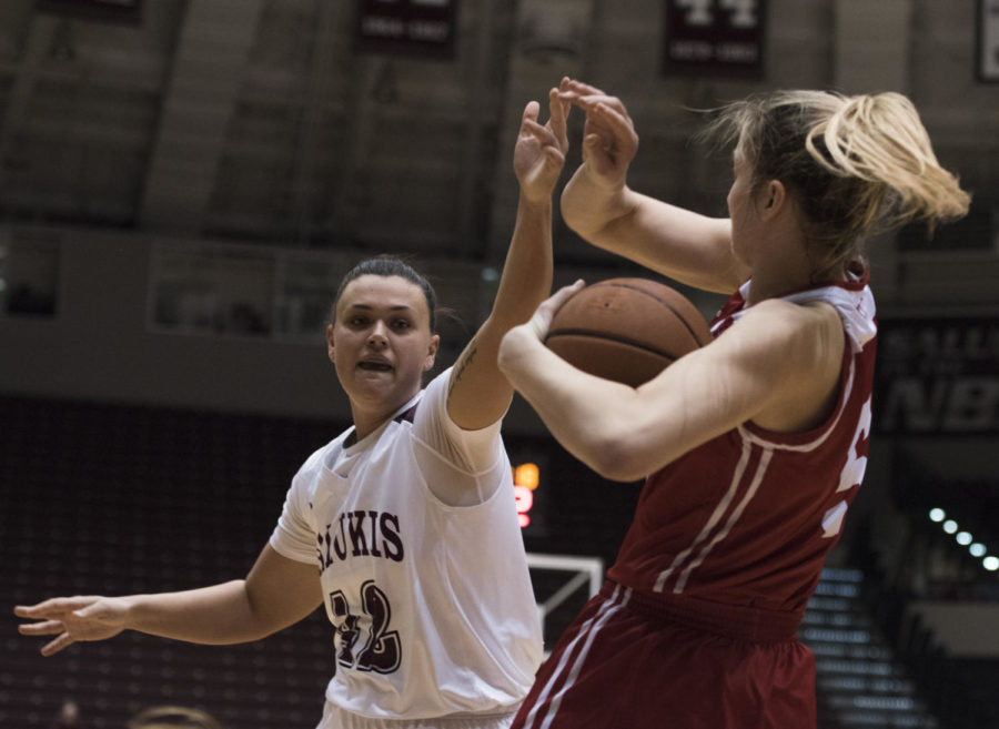 Junior forward/center Ashley Hummel reaches to snag the ball from Braves Sophomore forward Chelsea Brackmann during a match-up against the Bradley University Braves, the Salukis lead by 9 for a final score of 62-53 on Sunday, Feb. 11, 2018 at The SIU Arena. (Dylan Nelson | @Dylan_Nelson99)