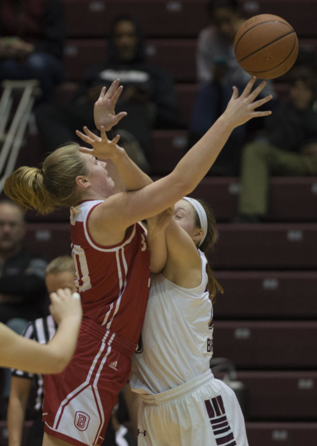 Freshman forward Abby Brockmeyer reaches to block the ball from Braves Freshman forward Emily Marsh during a match-up against the Bradley University Braves, the Salukis lead by 9 for a final score of 62-53 on Sunday, Feb. 11, 2018 at The SIU Arena. (Dylan Nelson | @Dylan_Nelson99)