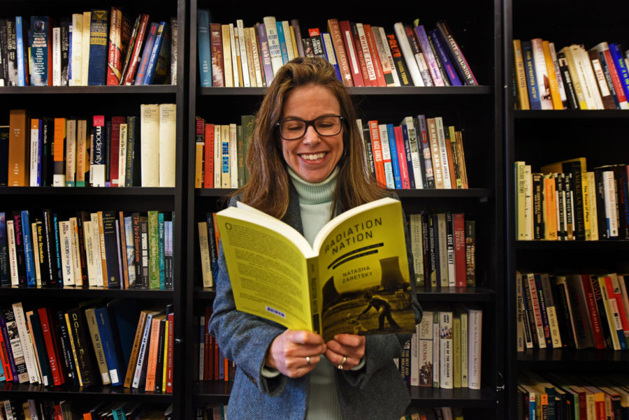 Natasha Zaretsky poses for a portrait with her book, Radiation Nation, on Tuesday, Feb. 6, 2018, in her Faner office. (Anna Spoerre | @annaspoerre) The book, focused on the 1979 nuclear accident at Three Mile Island, was published this year.