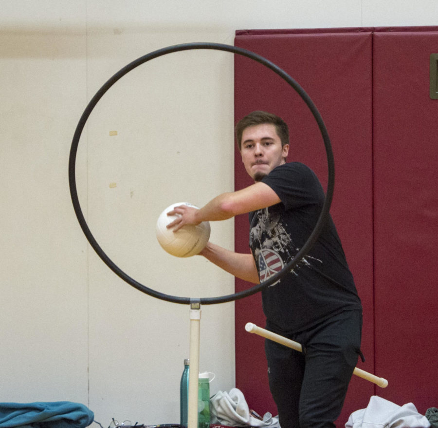 Sophomore Radio, Television and Design major Alex Albensoeder, 20, passes a ball through the goal Monday, Jan. 29, 2018 during quidditch practice at the student recreation center in Carbondale. (Dylan Nelson | @Dylan_Nelson99)