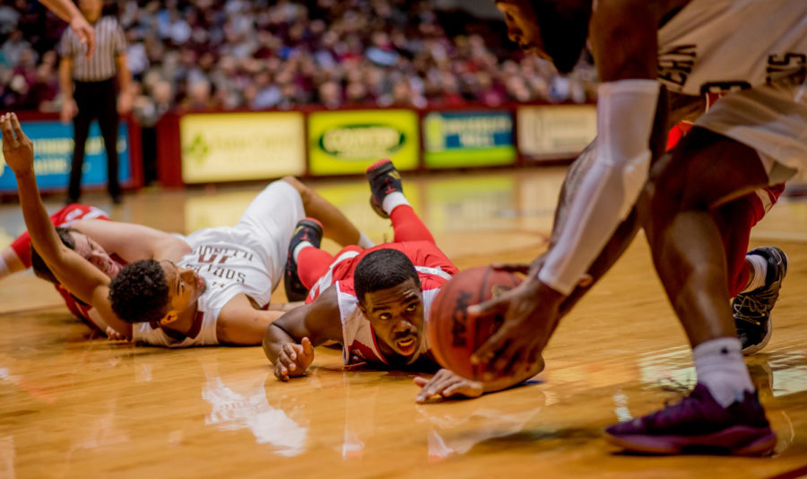 Bradley University forward Elijah Childs watches as Southern's Sean Lloyd Jr. picks up the ball after a scuffle with Southern's Aaron Cook on Sunday, Feb. 11, 2018, during the Salukis' 74-57 win against the Bradley Braves at SIU Arena. The Salukis are now the lone second place team in the Missouri Valley Conference. 