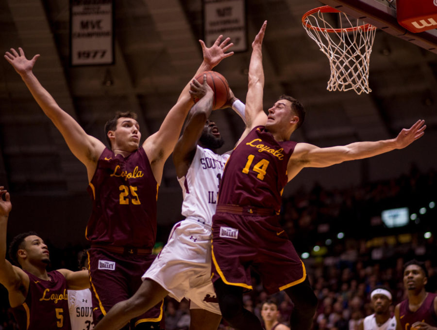 Junior guard Sean Lloyd Jr. goes for a basket Loyola center Cameron Krutwig and guard Ben Richardson Wednesday, Feb. 21, 2018, during the Loyola Ramblers 75-68 victory against the Southern Illinois University Salukis at SIU Arena. (Brian Munoz | @BrianMMunoz)