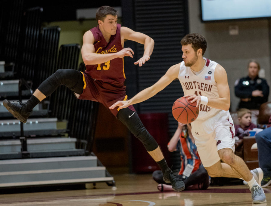 Senior guard Tyler Smithpeters drives the ball past Loyola guard Clayton Custer Wednesday, Feb. 21, 2018, during the Loyola Ramblers 75-68 victory against the Southern Illinois University Salukis at SIU Arena. (Cameron Hupp | @CHupp04)