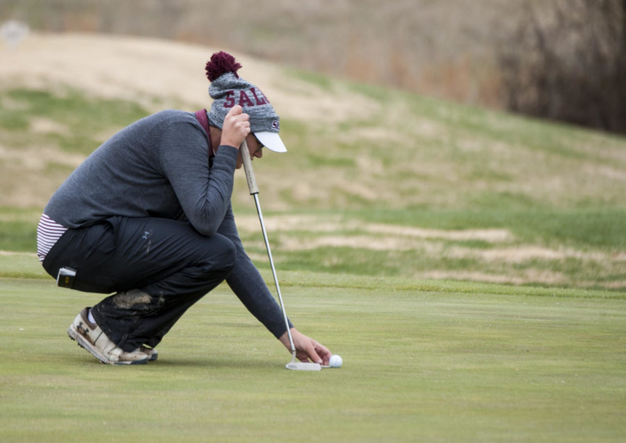 Sophomore Lili Klekner-Alt, of Ottawa, Ontario, Canada, replaces her ball on the green, Sunday, March 25, 2018, during the 24th annual Saluki Invitational at Hickory Ridge Golf Course in Carbondale. (Mary Newman | @MaryNewmanDE)