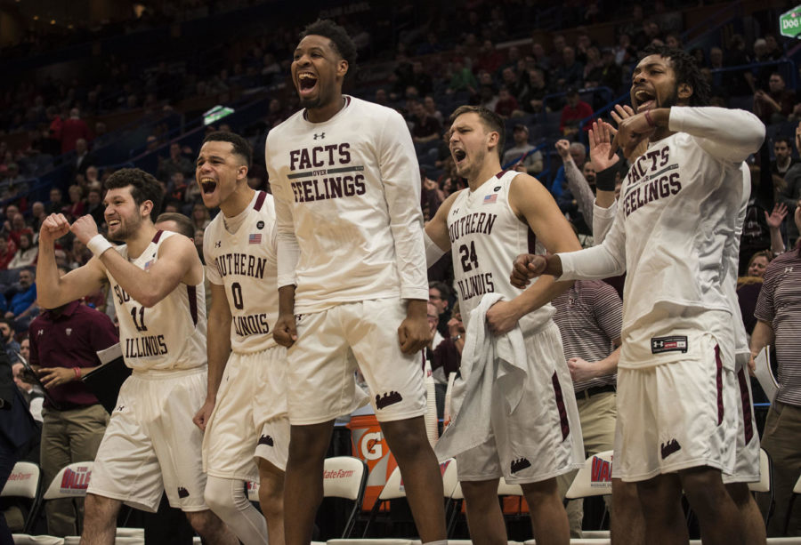 Members of the SIU men’s basetball team celebrate a point Friday, March. 3, 2018, during the Salukis’ 67-63 win against the Missouri State Bears at the MVC tournament in St. Louis. (Athena Chrysanthou | @Chrysant1Athena)