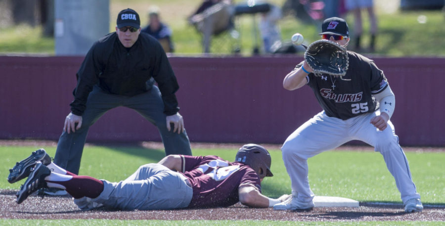 Senior first baseman Logan Blackfan catches the ball in an attempt to tag out a Warhawk Sunday, March 4, 2018, during the Warkhawks 13-7 win against the Salukis at Itchy Jones Stadium. (Dylan Nelson | @Dylan_Nelson99)