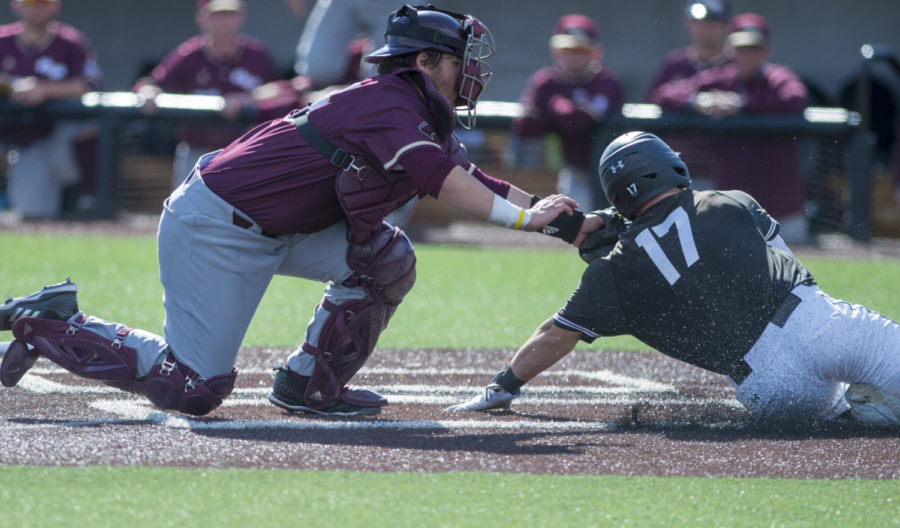 Sophomore catcher Austin Ulick slides home to be tagged out by Warhawks catcher Sunday, March 4, 2018, during the Warkhawks 13-7 win against the Salukis at Itchy Jones Stadium. (Dylan Nelson | @Dylan_Nelson99)