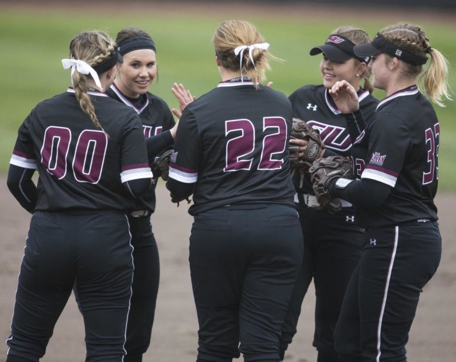 SIU Softball members give each other encouragement before the start of the game Sunday, March 25, 2018, during the Blackout Cancer game, where the Salukis took a 6-3 win against Illinois State University, at Charlotte West Stadium. (Corrin Hunt | @CorrinIHunt)