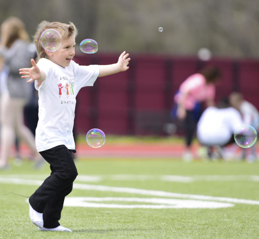 Dalton Gibson, 5, of Jonesboro, runs after bubbles, Saturday, April 21, 2018, during the Autism Society of Southern Illinois 5K color run childrens event at SIUs Lew Hartzog Track Complex. (Mary Newman | @MaryNewmanDE)
