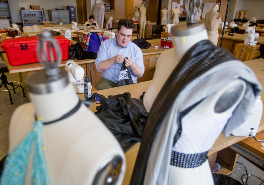 Joshua Gavel, a senior studying fashion design and merchandising from Champaign, puts together clothing for the senior design runway show Monday, April 2, 2018, in the fashion merchandising studio in Quigley Hall. 