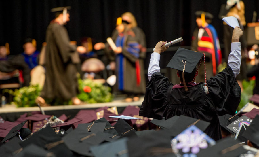 A bachelors degree recipient celebrates on Saturday, May 12, 2018, during the 142nd SIU commencement ceremony in the SIU Arena. (Brian Munoz | @BrianMMunoz)