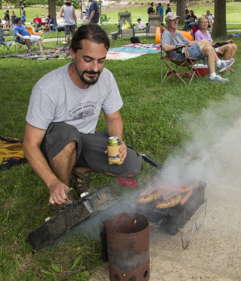 Nathan Bluw of Carbondale grills hot dogs and bratwursts, Thursday, June 14, 2018, during Down North’s set at the Sunset Concert Series outside of Shryock Auditorium. (Nick Knappenburger)