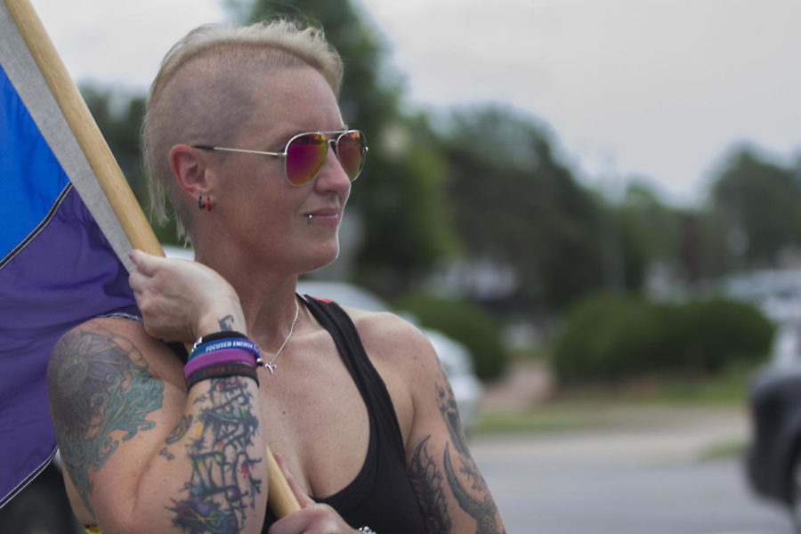 Julie Socorro waits for the last of the Pride March participants to cross  East Main Street. Socorro is Southern Illinois only drag king and helps out at the Rainbow Cafe in Carbondale. Socorro says that she is at the march to celebrate and push equality, Saturday, June 2, 2018, outside the Carbondale Pavilion (Isabel Miller)