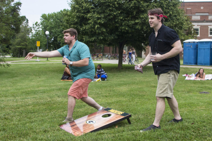 Wyatt Mayers and Henry Jones play a game of Bean Bags, Thursday, June 14, 2018, during Down North’s set at the Sunset Concert Series outside of Shryock Auditorium. (Nick Knappenburger)