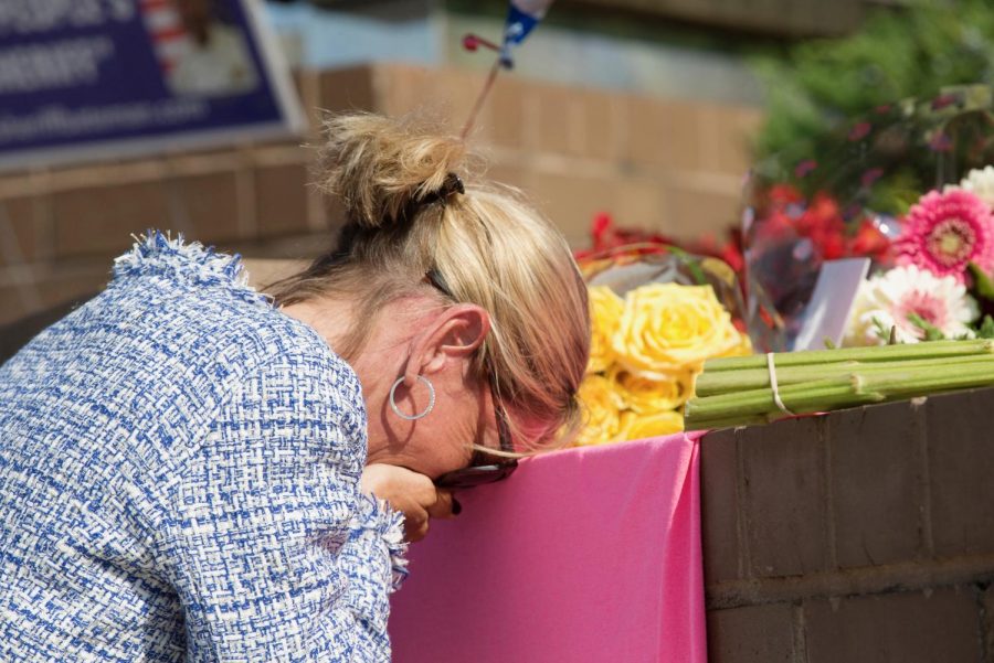 An unidentified mourner grieves at a small memorial set up at the entrance of 888 Bestgate Road on Friday, June 29, 2018. A gunman blasted his way into the Capital Gazette newsroom in Annapolis with a shotgun Thursday afternoon, killing five people and injuring two others, authorities said. (Jen Rynda/Capital Gazette/TNS)