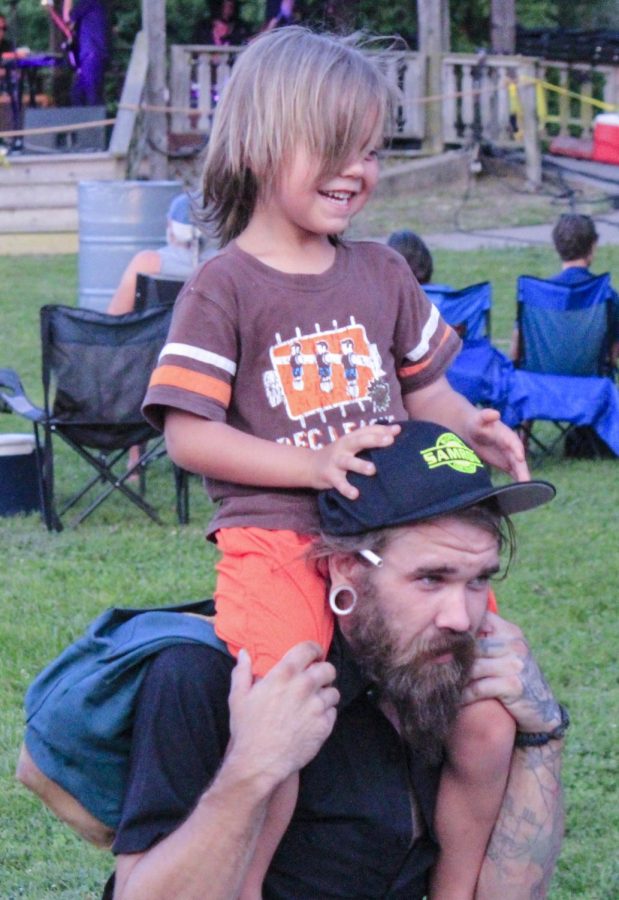 A father carrys his son on his shoulders, Thursday, July 5, 2018, at the Dos Santos Concert at Lenus Turley Park for the fourth Sunset Concert of the series (Nick Knappenburger)