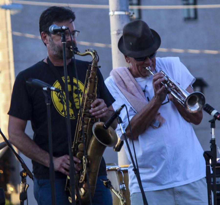 Klaus Bank plays the saxaphone while D. Ward plays the trumpet, Thursday, July 12, 2018, at the Jungle Dogs concert at the Conrner of Route 13 and Washington Street for the Sunset Summer Concert Series. (Nick Knappenburger)