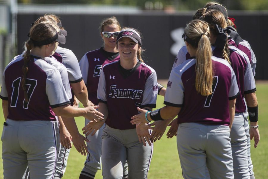 Junior outfielder, Sidney Sikes, runs through her teammates Sunday, Sept. 16, 2018, during the Salukis’ 2-0 win against the John A. Logan Volunteers at Charlotte West Stadium. (Isabel Miller | @IsabelMillerDE)