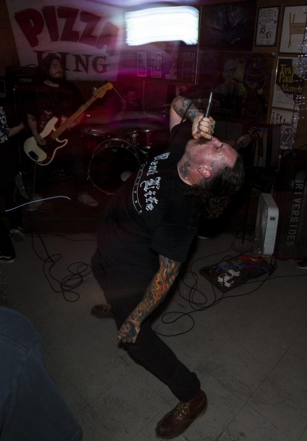 Jonathan Clapp, of Carbondale, throws his head back and screams, Tuesday, Sept. 19, 2018, during Lowered A.D.’s performance at PK’s. (Mary Barnhart | @MaryBarnhartDE)