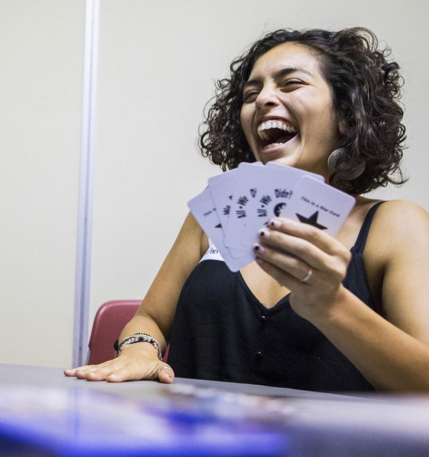 Shayla, a graduate student at SIU, plays a card game Friday, Sept. 14, 2018, after the A.L.I.A.S. RSO meeting at the Student Center. Shayla said she joined the group because it fits in with her lifestyle and sexual identity. (Corrin Hunt | @CorrinlHunt)