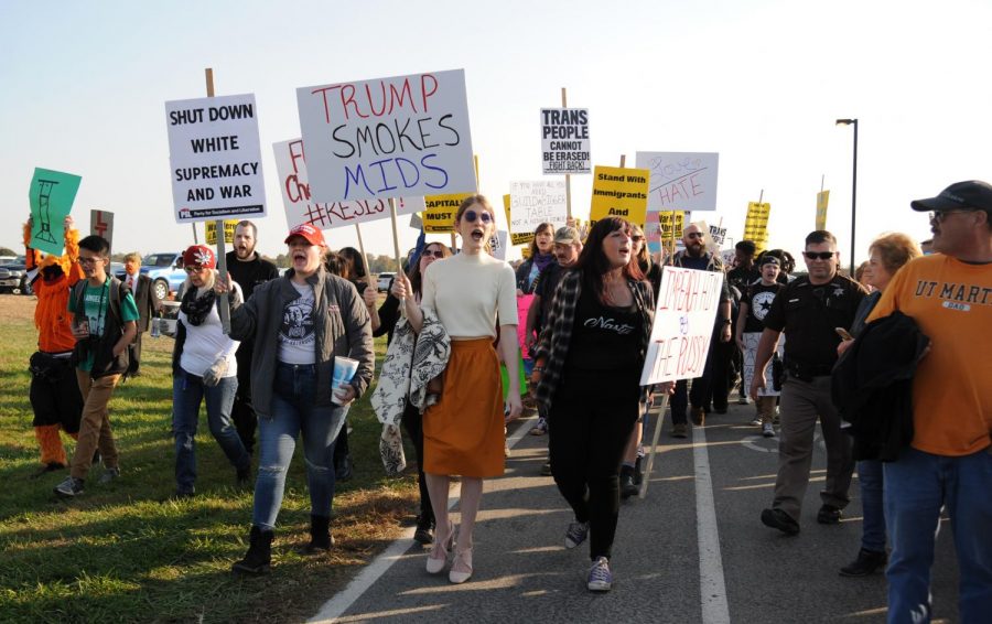 Protesters walk alongside President Trump supporters waiting in line during the MAGA Rally, Saturday, Oct. 27, 2018, at the Southern Illinois Airport in Murphysboro. (Mary Barnhart | @MaryBarnhartDE)