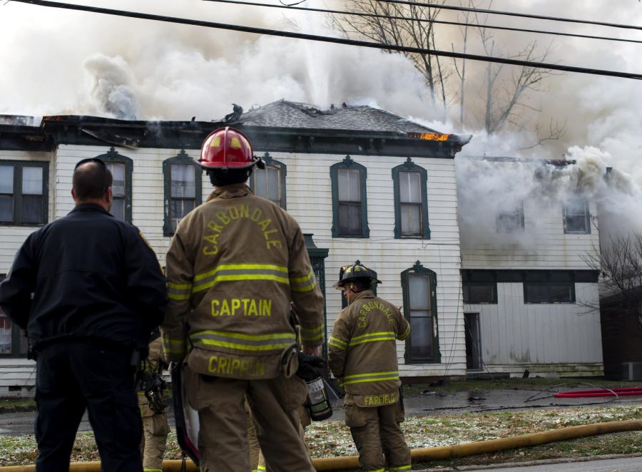 Firefighters put out fire on the corner of Poplar and Route 13, Tuesday, Nov. 13, 2018. The Fire Department has not yet released a statement. The house is regarded as the ‘oldest’ in Carbondale. (Isabel Miller | @IsabelMillerDE)