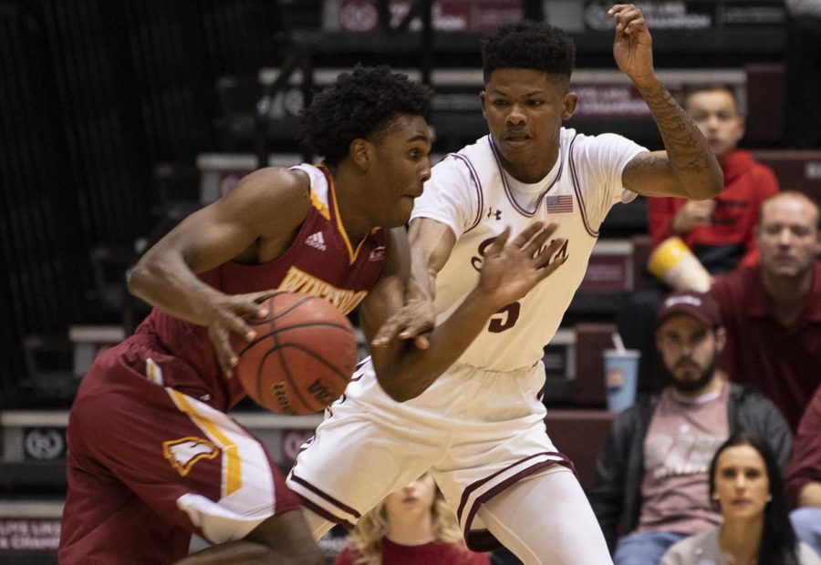 Freshman guard Darius Beane attempts to block an Eagle on Saturday, Dec. 22, 2018, during the Salukis 71-79 loss against the Winthrop University Eagles at SIU Arena.