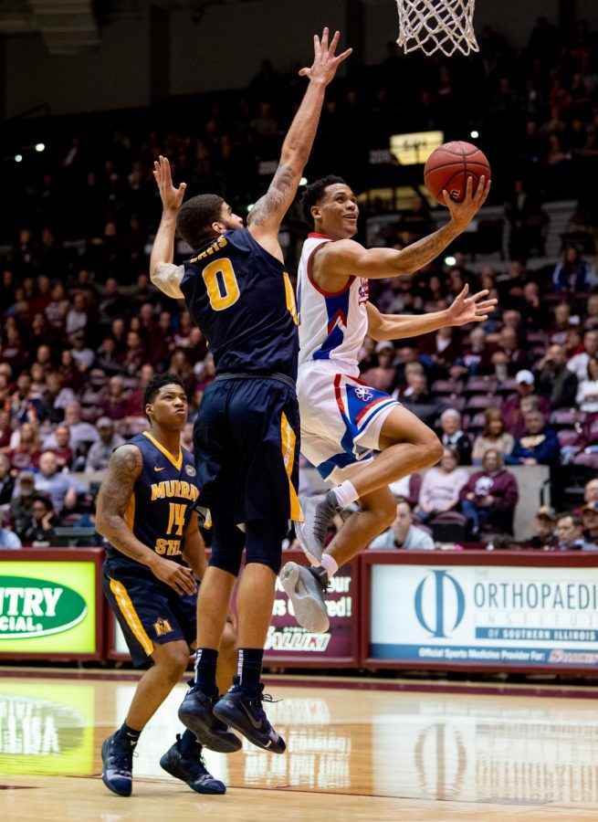 Southern Illinois junior guard Eric McGill attempts to go for a basket while under Racer pressure on Wednesday, December 12, 2018 during the second half of the Salukis matchup against the Murray State Racers.  
