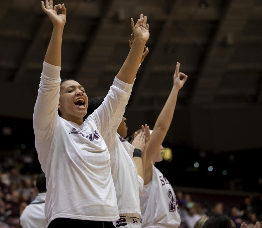 Junior forward Gabby Walker holds up three fingers after a three point shot made by Sophomore guard Makenzie made a three point basket on Friday, Jan. 4, 2019, during the Salukis 47-64 win against the Evansville Purple Aces at SIU Arena. 
