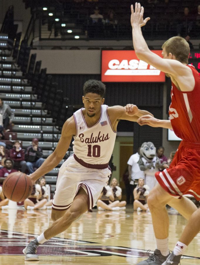 Junior guard Aaron Cook advances the ball past a member of the Braves Sunday, Jan. 20, 2019, during the Bradley Braves 57-54 win over the Southern Illinois Salukis at SIU Arena. 