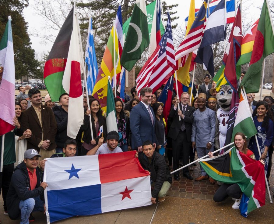 International students pose alongside Executive Director of International Affairs Andrew Carver, and SIU Chancellor John Dunn, on Monday, Feb. 4, 2019, during the International Parade of Flags on SIU’s campus.