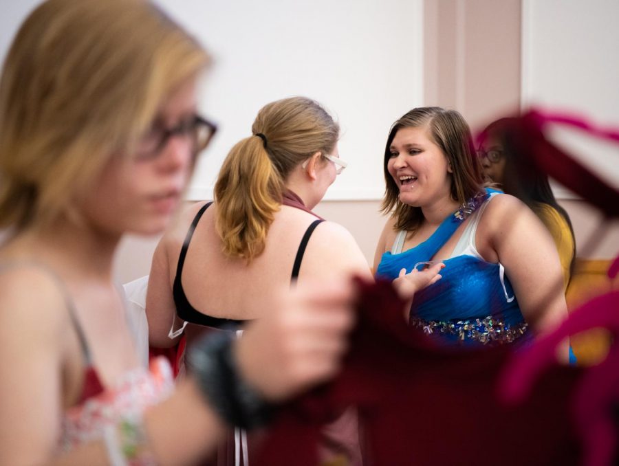 Olivia Krammer, from West Frankfort, shows a dress to her friends on Sunday, March 31, 2019 at the Carbondale Civic Center during a prom dress giveaway hosted by the Prom Boutique.  Krammer came to the event with her school.
