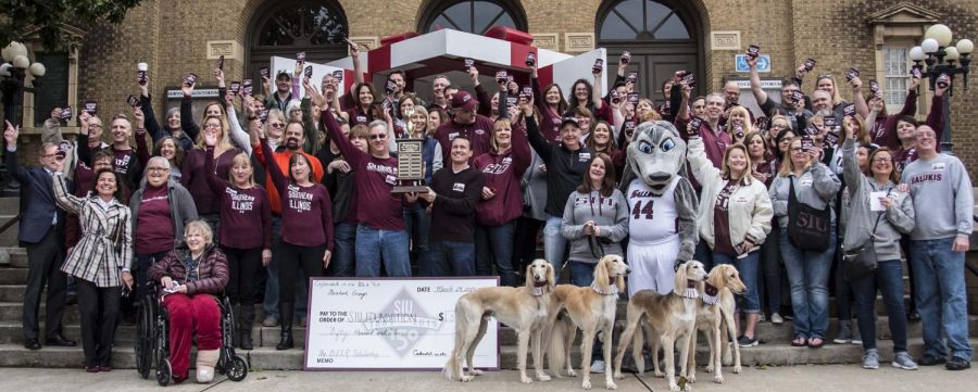 Attendees gather for a group photo during the BEER scholarship trophy presentation on Friday, March 29, 2019 during the SIU Day of Giving outside Shryock Auditorium.