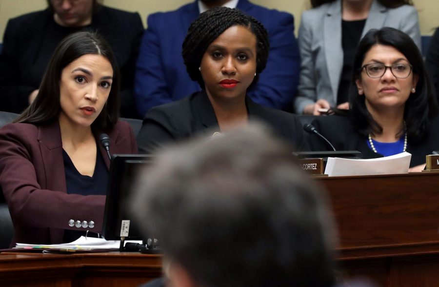 (L-R) Rep. Alexandria Ocasio-Cortez (D-NY), Rep. Ayanna Pressley (D-MA) and Rep. Rashida Tlaib (D-MI) listen as Michael Cohen, former attorney and fixer for President Donald Trump, testifies before the House Oversight Committee on Capitol Hill Feb. 27, 2019 in Washington, DC. Last year Cohen was sentenced to three years in prison and ordered to pay a $50,000 fine for tax evasion, making false statements to a financial institution, unlawful excessive campaign contributions and lying to Congress as part of special counsel Robert Muellers investigation into Russian meddling in the 2016 presidential elections.