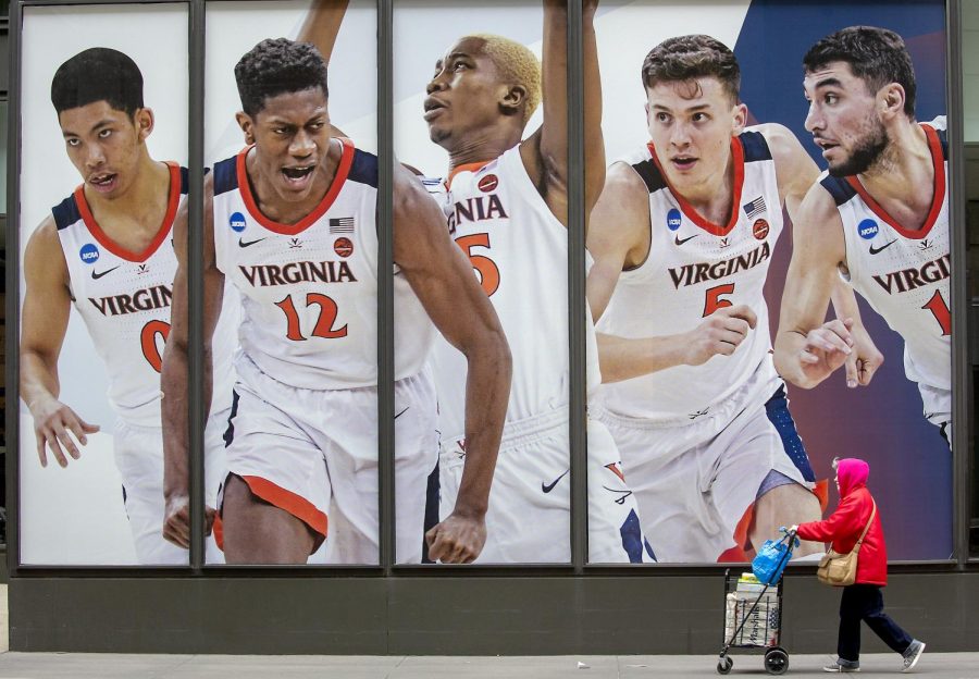 Pedestrians made their way by giant-sized posters of Final Four players near 7th Street and Marquette Avenue on the windows of the IDS Center, Monday, April 1, 2019 in Minneapolis, Minn.
