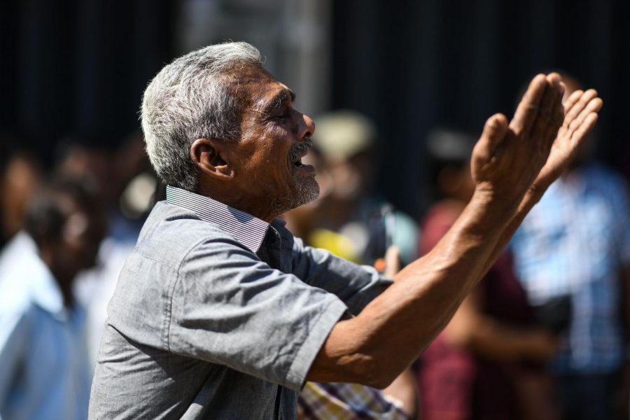 A man cries as he prays outside the St. Anthonys Shrine in Colombo on April 22, 2019, a day after the building was hit as part of a series of bomb blasts targeting churches and luxury hotels in Sri Lanka. - The death toll from bomb blasts that ripped through churches and luxury hotels in Sri Lanka rose dramatically April 22 to 290 -- including dozens of foreigners -- as police announced new arrests over the countrys worst attacks for more than a decade.