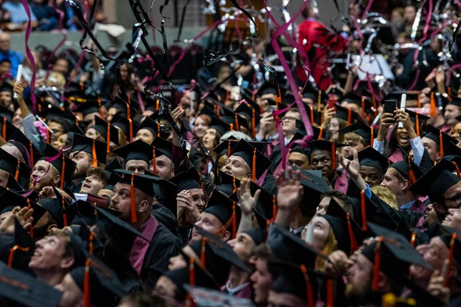 Graduated students react as confetti falls down on them on Saturday, May 11, 2019 during the 2019 commencement inside the SIU Arena. 